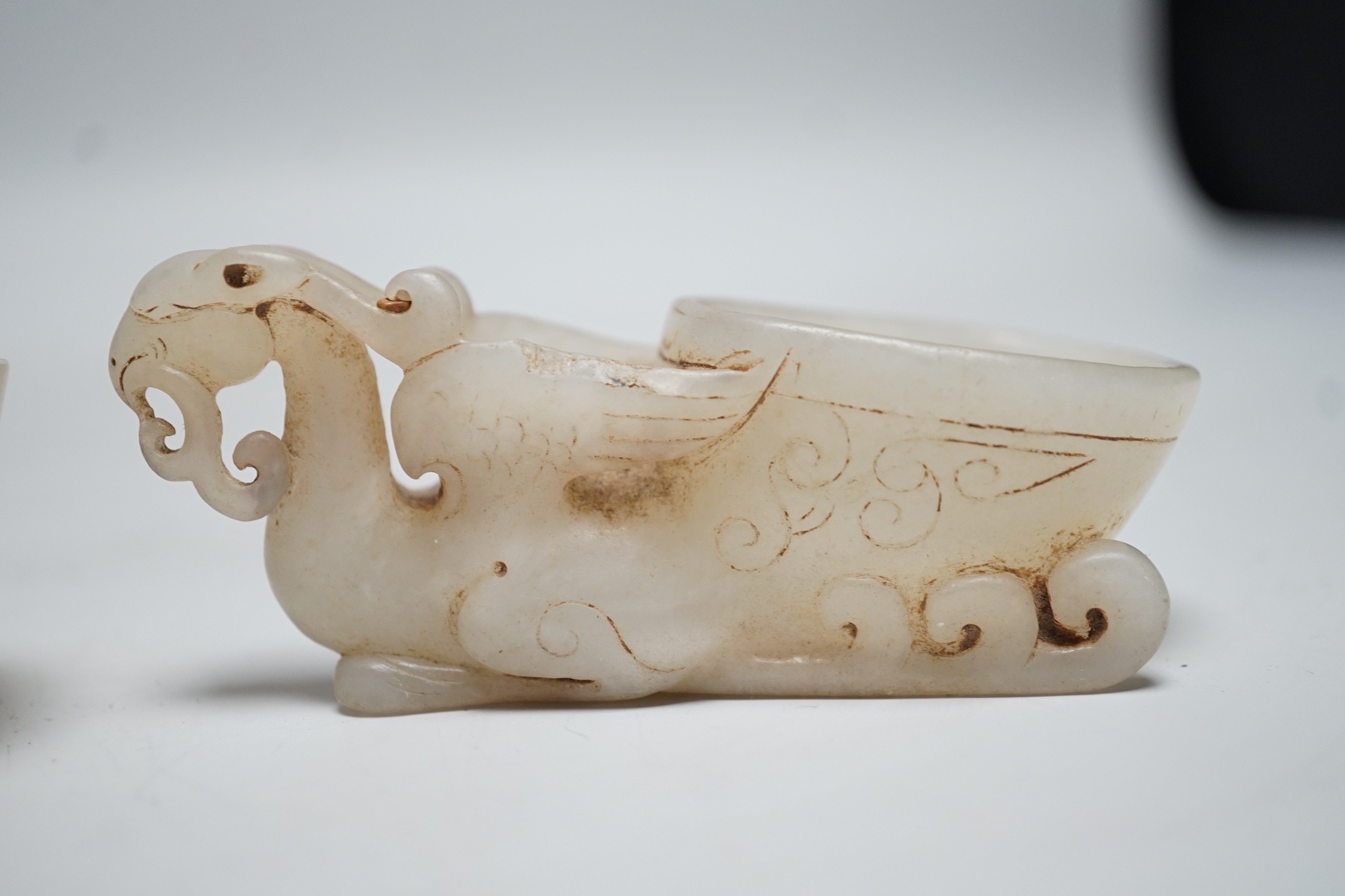 A Chinese hardstone rhyton cup and a bowenite jade cup, largest 9cm